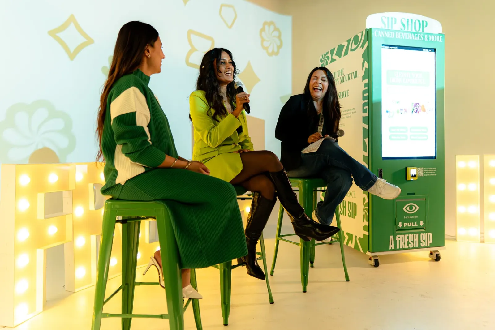 Panel speakers at the A Fresh Sip launch event beside the branded Sip Shop vending machine
